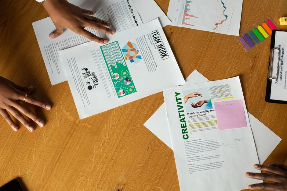 A top-down view of charts and a smartphone in an office, presenting data analytics.